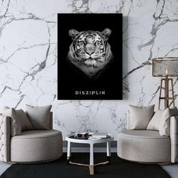 "Canvas picture with a black and white image of a tiger and the text 'DISZIPLIN'. Available in various framed sizes."
The image shows a black and white canvas picture of a tiger's face. The tiger has a fierce, intense expression and the image is set against a dark background. The text "DISZIPLIN" is displayed below the tiger's face.
This canvas picture would be suitable for display in a modern, minimalist interior. The black and white color scheme and bold, graphic design make it an eye-catching piece of wall art. The different framed size options allow customers to choose the best fit for their space.
