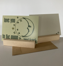 Greeting card with a moon and stars design, featuring the text "love you to the moon and back".