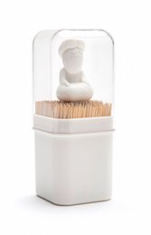 White ceramic toothpick holder with a figurine design.