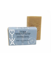 A honey-scented body cleanser in a rectangular bar form. The bar is a warm, golden color and has a simple, minimalist design.
