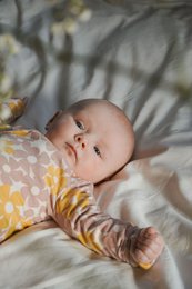 Soft, floral-patterned baby shirt in pastel colors. Made of comfortable, breathable fabric suitable for infants.