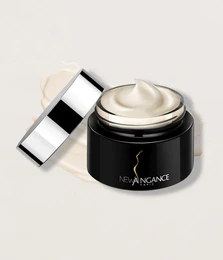 Precious face cream in a black jar with silver lid. Luxurious skincare product for nourishing and rejuvenating the skin.