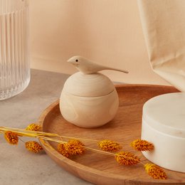  Wooden dove-shaped jewelry box with a round, smooth design and a natural, minimalist aesthetic.