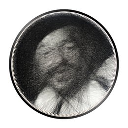 Round black and white abstract wall art with swirling lines and shapes.