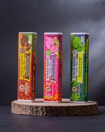 Colorful energy bars with natural ingredients, chocolate carob flavor, vibrant pink yellow brown packaging, organic superfood snacks.