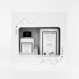 A hydration kit for babies and kids, containing body lotion and body oil in a minimalist black and white design.
