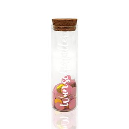 A clear glass gift tube with a cork lid, containing pink and yellow confetti. The text on the tube reads "WUNSCHERFULLLER" in white lettering.