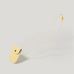Yellow leather pouch for kids, with a simple and minimalist design.