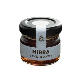Raw pine honey in a 30-gram glass jar with a black and white label. The honey has a rich, golden color and a smooth, creamy texture.