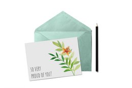 Greeting card with floral design and text "So very proud of you!" in Dutch. The card is enclosed in a mint green envelope.