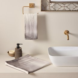 Cream and gray cotton slub bath towels, soft textured fabric, absorbent bathroom set with natural aesthetic.