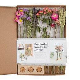 Dried flower box with pink and purple flowers in glass vases.
The product is a dried flower box that includes several glass vases filled with a variety of dried flowers in shades of pink and purple. The flowers have a natural, rustic appearance and are arranged in a visually appealing way within the box. This product would be suitable for use as a decorative centerpiece or gift.