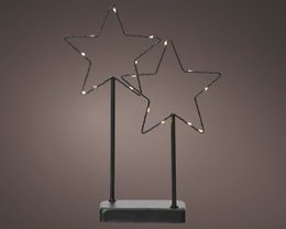 A tall, metal star-shaped Christmas light decoration with multiple LED lights illuminating the star shapes.