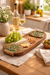 Handcrafted wooden serving board with carved green grapes design, suitable for serving appetizers, cheese, or other small bites.