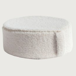Soft, round, fluffy white meditation pillow with a teddy bear design, suitable for relaxation and comfort.