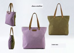 A large, canvas tote bag in a light purple color with brown leather handles and trim. The bag has a simple, minimalist design that would be suitable for everyday use or as a shopping bag.