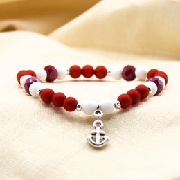 Red and white beaded bracelet with anchor charm, suitable for casual or nautical-themed outfits.