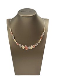 Delicate necklace with oval-shaped beads in pastel colors, complemented by matching earrings.