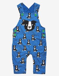 Organic cotton dungarees with a playful dog print, available in sizes 3-6m to 3-4y. The overall style is casual and comfortable, with a blue background and various dog illustrations throughout.