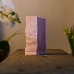 Organic lavender-scented soap bar with a rectangular shape and a marbled pink and purple color.