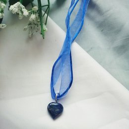 Blue necklace with heart-shaped sodalite gemstone pendant.