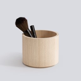 Wooden desk organizer with medium-sized cylindrical shape, made of natural wood material.