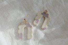 Delicate white and pink pom-pom earrings with gold-tone hardware.