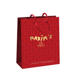 A red paper gift bag with the text "Maxim's" printed in gold. The bag measures 21 x 18 cms and is suitable for gift-giving.