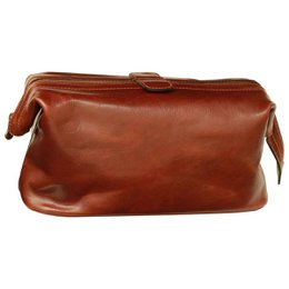  A brown leather beauty case with a zipper closure and a strap for carrying. The case appears to be made of high-quality leather and is suitable for storing toiletry items.