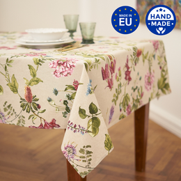 Rectangular tablecloth made of poly-cotton mix fabric, featuring a printed botanical design with pink flowers and green leaves.