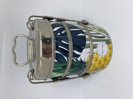 Stainless steel lunch box with pineapple design, featuring a colorful tropical leaf pattern in green, yellow, and black.