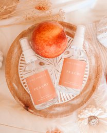 Peachy room spray, peach fragrance, orange-coral color, glass bottle, home fragrance, linen spray.
