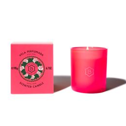 A tall, round, pink candle with a rose design on the label. The candle is scented and comes in a red box.