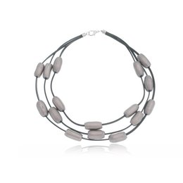 Silver-toned ceramic tubes strung on a multi-strand necklace with a sleek, modern design.