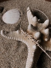 Delicate silver charm bracelet with signature charm, perfect for everyday wear.