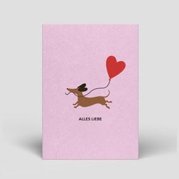 Dachshund with heart-shaped balloon, pink background, text "Alles Liebe" (All the best)