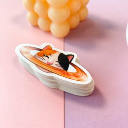 Vinyl sticker featuring a cat-shaped spacecraft or UFO design in orange and black colors.