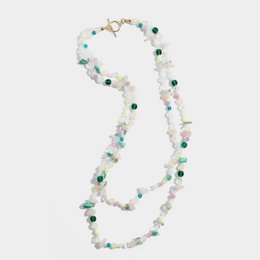  A long, elegant gold-plated beaded necklace with turquoise and white beads, featuring a delicate and feminine design.