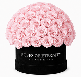 A large bouquet of vibrant red roses in a black box, with the text "Roses of Eternity" on the box.
The image shows a large bouquet of approximately 50 deep red roses arranged in a round shape and placed in a black box. The box is labeled "Roses of Eternity" in white text. The roses appear to be fresh and full, with a rich, velvety texture. This arrangement would be suitable for a special occasion or as a luxurious gift.