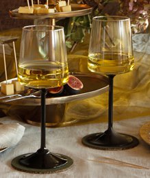 "Set of six white wine glasses with black stems, clear glass, modern elegant design for wine serving"