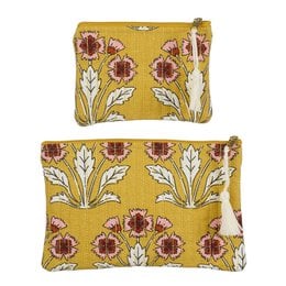 Two yellow toiletry bags with floral patterns in shades of red and green.
