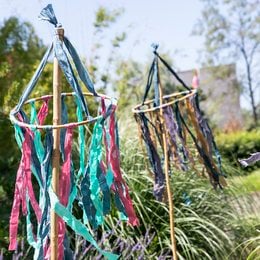 Colorful tassel mobile with khaki, blue, and pink tassels. Decorative party bunting for indoor or outdoor use.