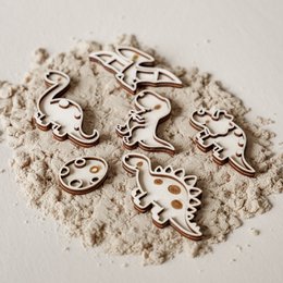  Small filling trays with dinosaur-themed shapes in various colors and materials. Includes shapes like dinosaurs, footprints, and other dinosaur-inspired designs.