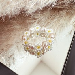 A delicate flower ring with daisies and freshwater pearls, perfect for stacking or wearing alone.