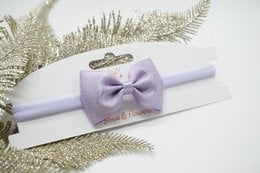 Nylon hairband with metallic satin baby bow in various colors including antique white, cream, tan, pink, pearl pink, rose pink, beauty, red, ocean blue, blue topaz, navy blue, lilac, grape, amethyst, green, gold, shell grey, and black. Suitable for kids' hair accessories.