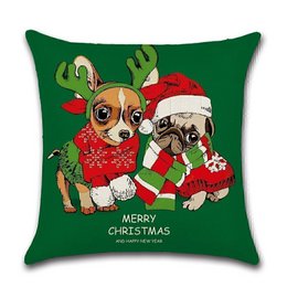 Cushion cover featuring two cute dogs wearing Christmas outfits and accessories, including a Santa hat, scarf, and antlers. The cushion cover has a festive green background and the text "Merry Christmas" printed on it.