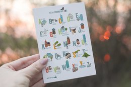 Colorful postcard with illustrated alphabet letters depicting various Frankfurt landmarks and icons.