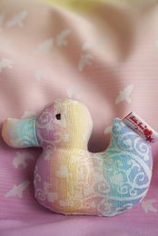 Clutching toy duck Marie in Wonderland