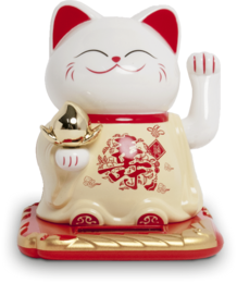  A white and red ceramic figurine of a lucky cat, also known as a Maneki-neko. The cat has a smiling expression and is waving its paw. The figurine is sitting on a red and gold base.