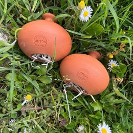 Orange, round, protective cocoons for drilling tools, suitable for gardening.